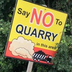 say no to quarry sign, with dust trail behind a truck illustration