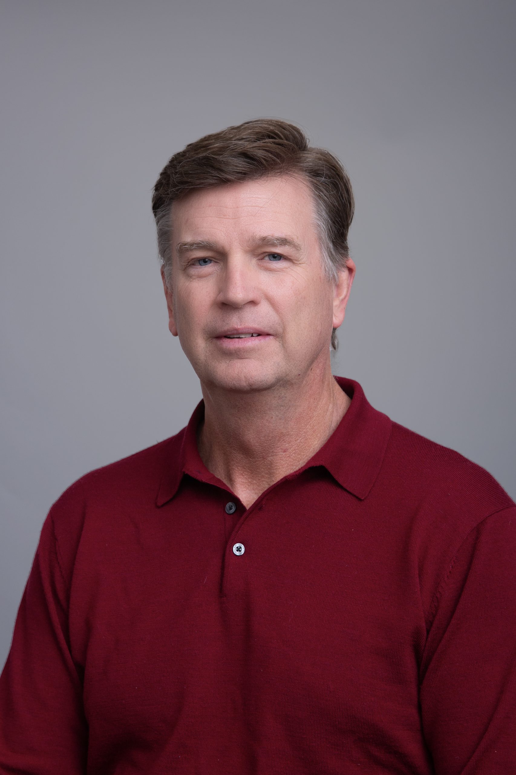 Director of Operations, Corey Johnson headshot, red polo